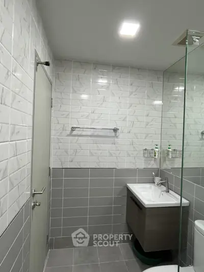 Modern bathroom with sleek tiles and glass shower enclosure