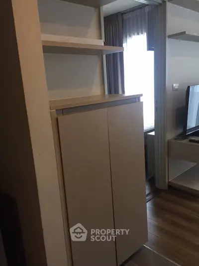Modern apartment interior with sleek storage unit and natural light
