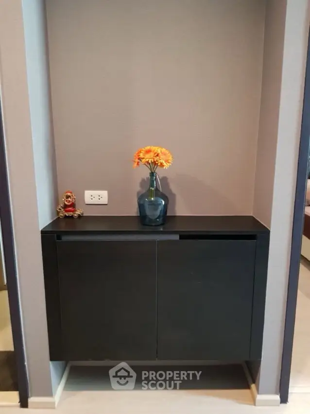 Stylish interior nook with modern cabinet and decorative vase in a contemporary home.