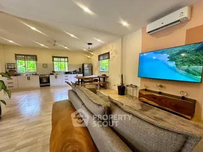 Spacious open-plan living room with modern kitchen and scenic views, perfect for entertaining.