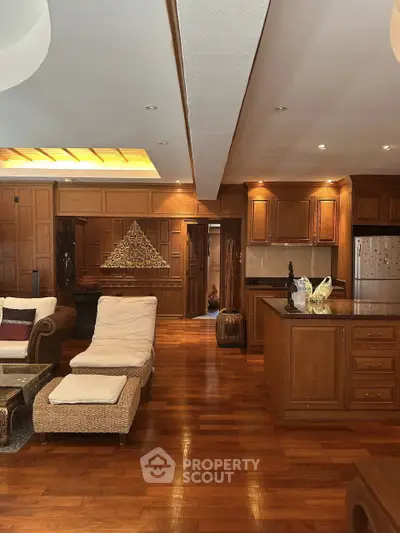 Luxurious living room with elegant wooden decor and open kitchen layout