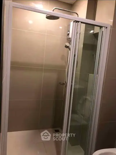 Modern bathroom with sleek shower enclosure and contemporary fixtures.