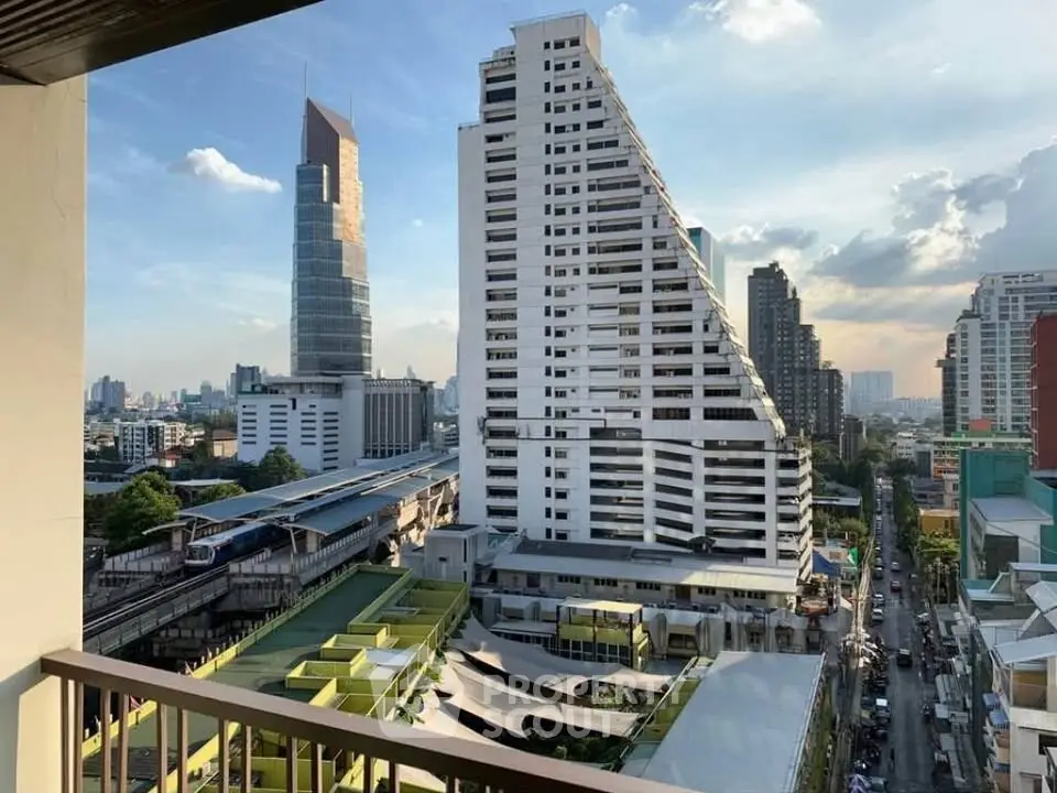 Stunning cityscape view from a high-rise balcony overlooking modern architecture and urban skyline.
