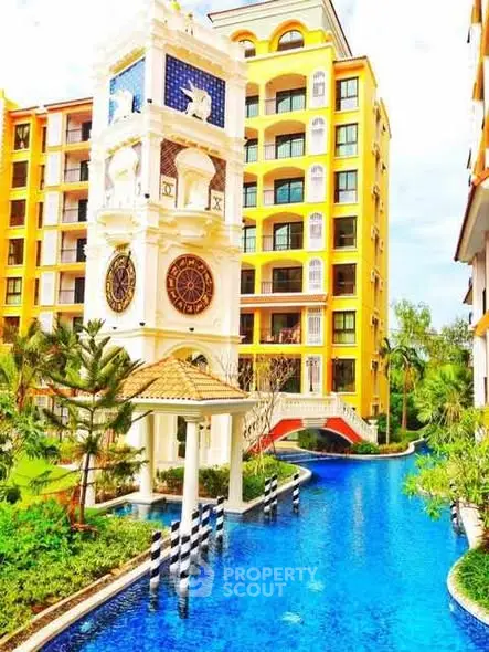 Luxurious apartment complex with stunning pool and clock tower feature.