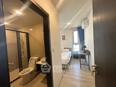 Modern apartment with cozy bedroom and sleek bathroom design