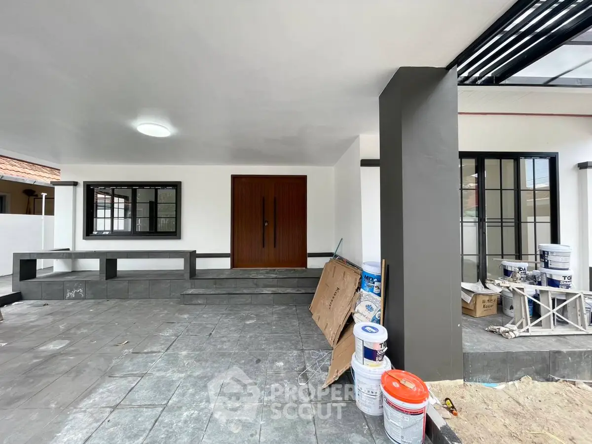 Modern home entrance with sleek design and spacious porch area