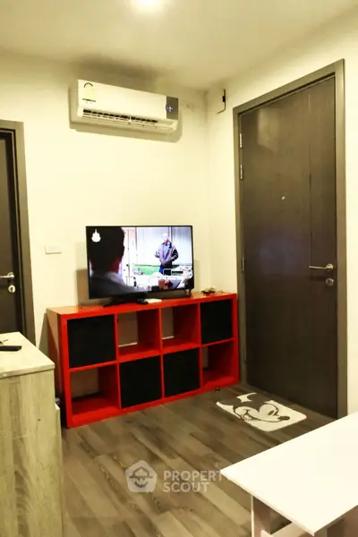 Modern living room with air conditioning and stylish red TV stand