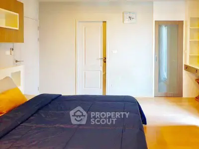 Spacious bedroom with modern design and ample natural light.