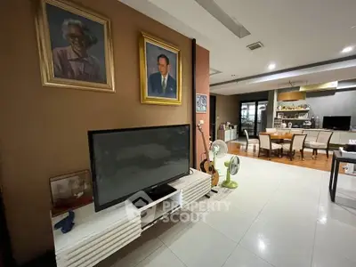 Spacious living room with modern decor and dining area, ideal for family gatherings.