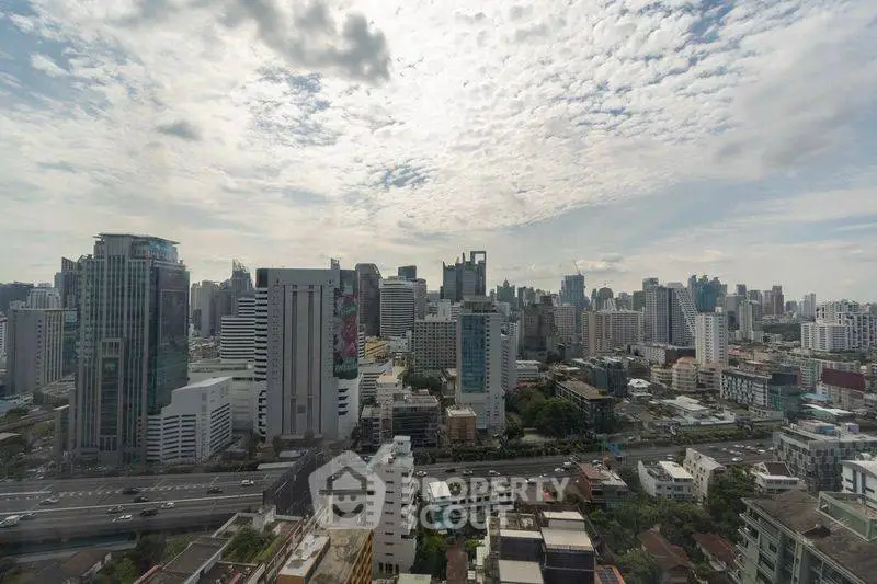 Stunning cityscape view showcasing a vibrant urban skyline with modern skyscrapers under a partly cloudy sky.