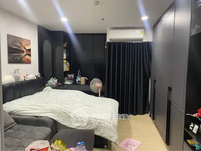 Cozy bedroom with modern decor, featuring a comfortable bed, stylish wardrobe, and air conditioning.