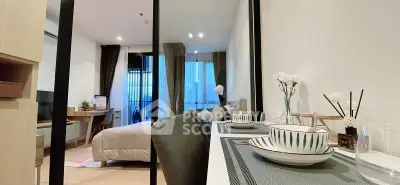 Modern studio apartment with stylish decor and cozy ambiance, featuring a dining area and comfortable bed.