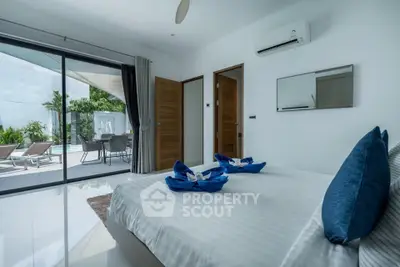 Luxurious bedroom with poolside view and modern decor