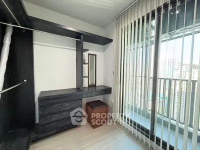 Spacious walk-in closet with balcony view in modern apartment