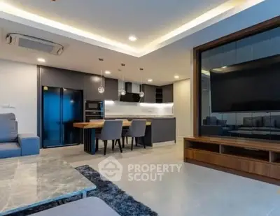 Modern open-plan living room with sleek kitchen and stylish decor