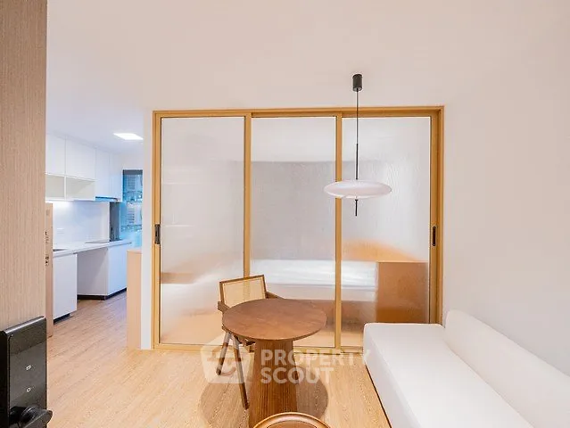 Modern minimalist living room with sliding doors and cozy seating area