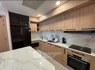 Modern kitchen with sleek wooden cabinets and marble countertops