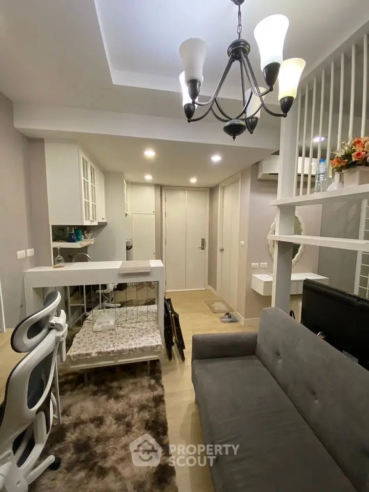 Modern living room with stylish chandelier and cozy seating area