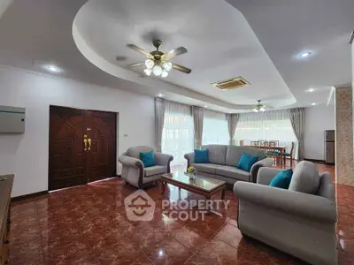Spacious living room with elegant ceiling design and cozy seating area