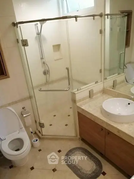 Modern bathroom with glass shower enclosure and elegant fixtures