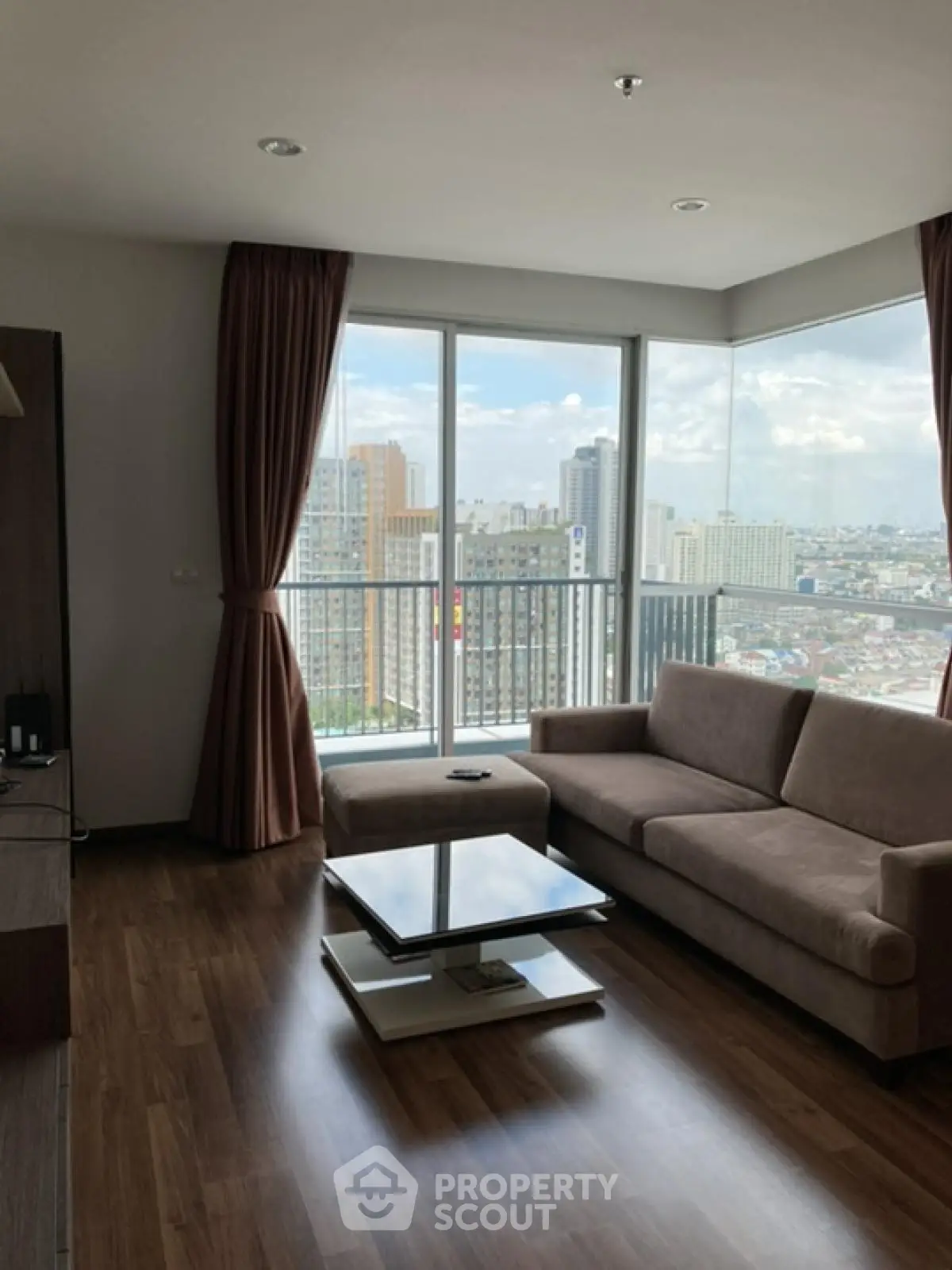 Modern living room with city view and stylish furniture in high-rise apartment