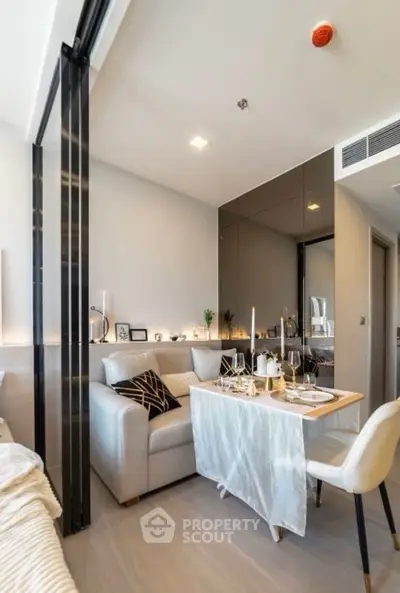 Modern living room with elegant dining setup and cozy seating area