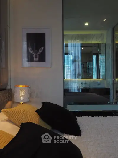 Luxurious bedroom with modern decor and city view, featuring elegant lighting and stylish artwork.