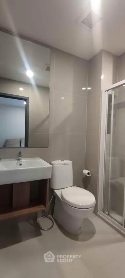 Modern bathroom with sleek fixtures and spacious shower area