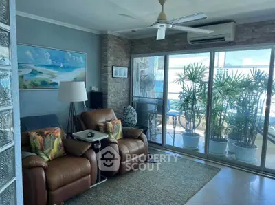 Cozy living room with leather recliners and balcony view