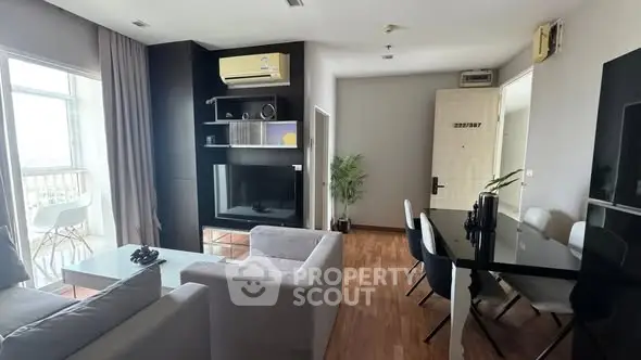 Modern living room with sleek furniture and balcony view