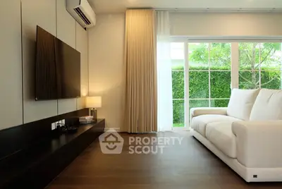 Modern living room with large window and sleek furniture