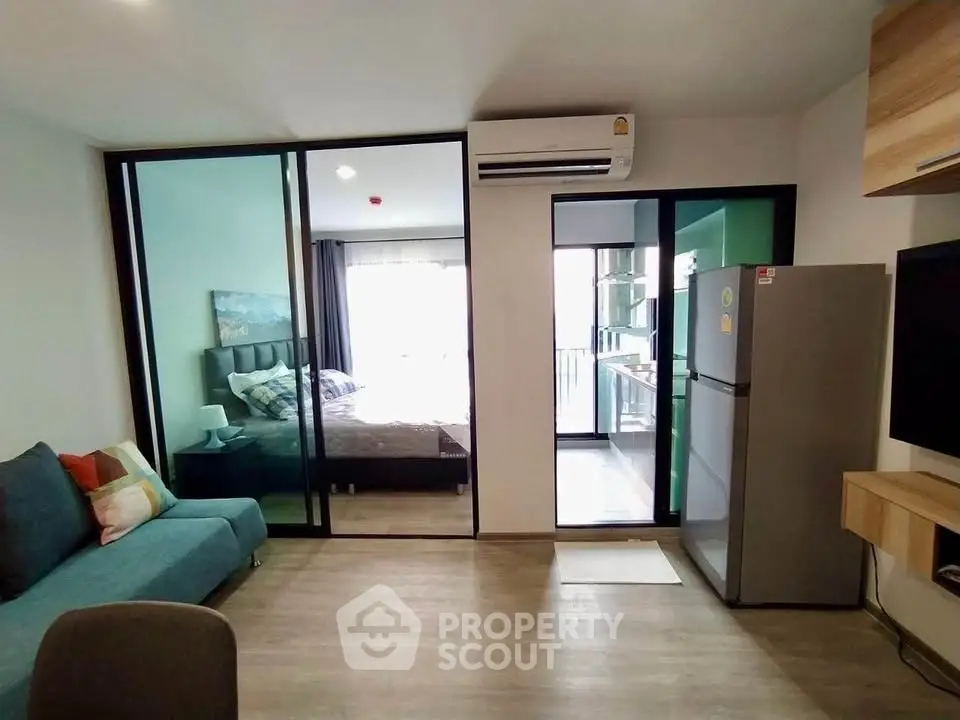 Modern apartment with open layout, featuring a cozy living area and bedroom with balcony access.