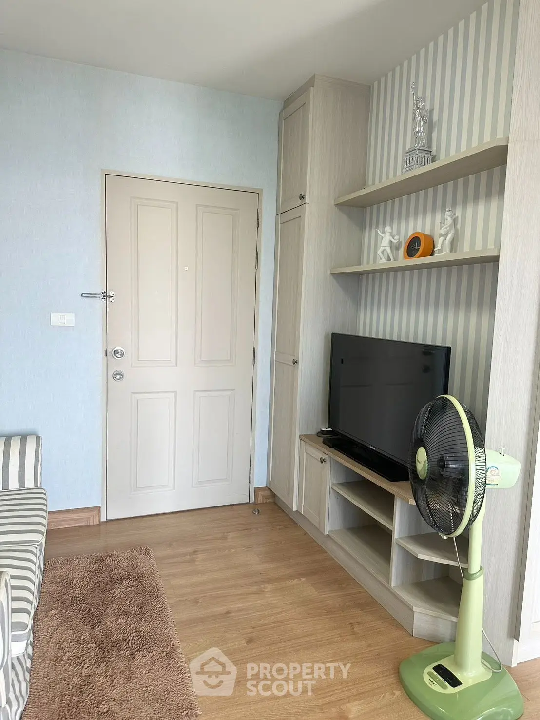 Cozy living room with modern decor and entertainment setup, featuring a stylish TV stand and comfortable seating.
