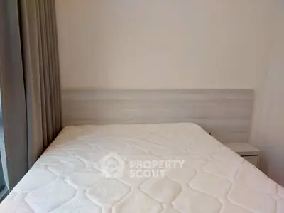 Cozy bedroom with a comfortable mattress and modern headboard, perfect for restful nights.