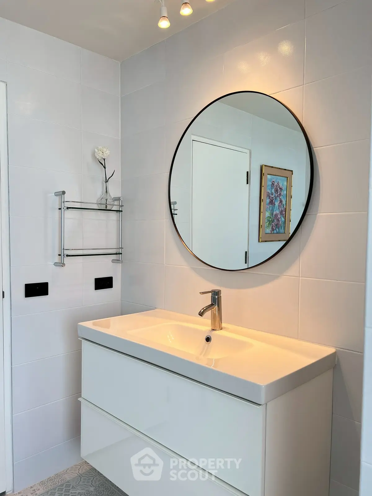 Modern bathroom with sleek vanity and round mirror