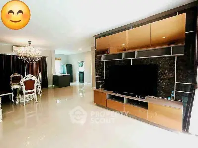 Spacious living room with elegant dining area and modern entertainment center.