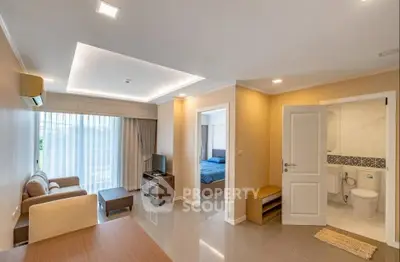 Modern apartment interior with living room, bedroom, and bathroom, featuring sleek design and ample natural light.
