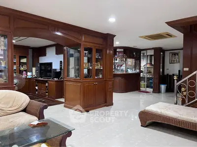 Spacious living room with wooden accents and modern furnishings in a cozy home setting.