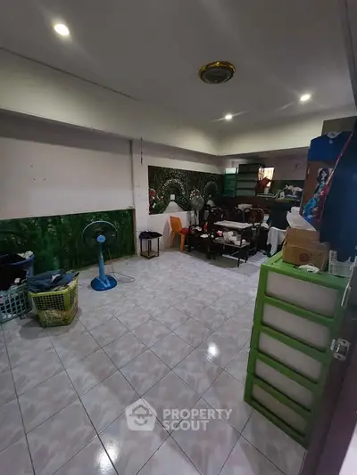 Spacious living room with tiled flooring and eclectic decor, perfect for creative customization.