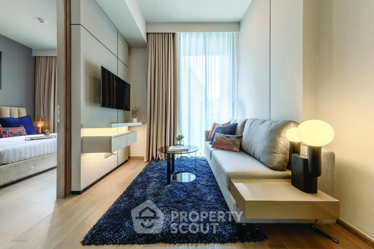 Modern living room with stylish decor and cozy ambiance, featuring a plush sofa and elegant lighting.