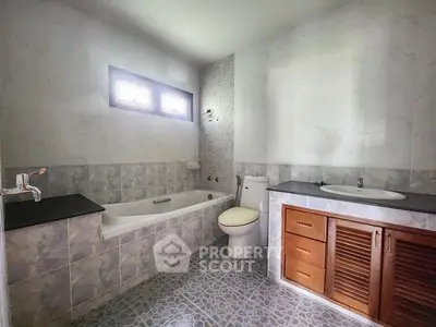 Spacious bathroom with bathtub and modern fixtures in a stylish home.