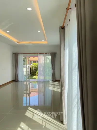 Spacious living room with elegant curtains and natural light