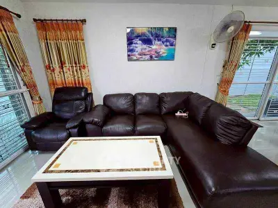 Spacious living room with leather sofa and elegant decor