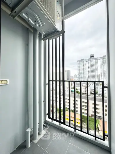 Modern balcony with city view and air conditioning unit, perfect for urban living.
