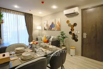 Modern dining and living area with stylish decor and natural light