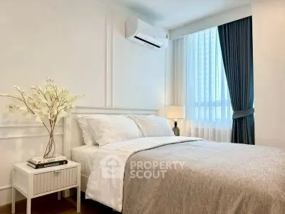 Elegant bedroom with modern decor and natural light, featuring a cozy bed and stylish curtains.