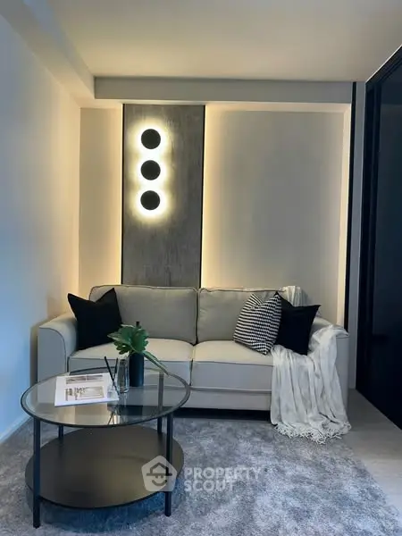 Modern living room with stylish lighting and cozy sofa setup