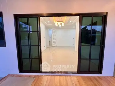 Modern living room with sliding glass doors and elegant lighting