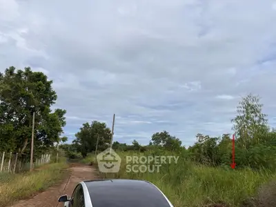 Scenic rural landscape with lush greenery and a clear sky, ideal for real estate development.