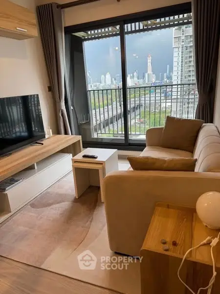 Modern living room with city view, cozy sofa, and large TV, perfect for urban living.